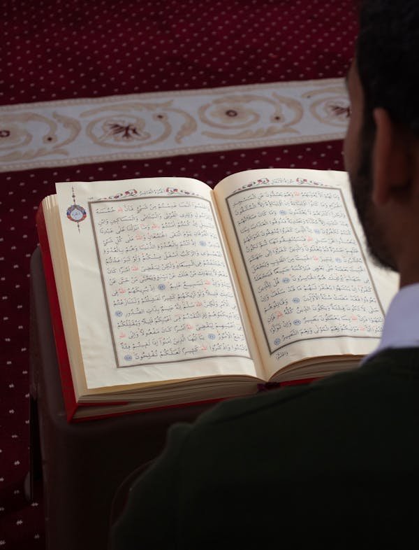 Man reading the Quran during prayer